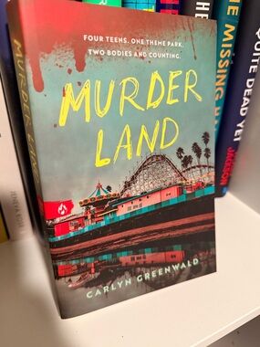 Murderland by Carlyn Greenwald - Teal & Yellow Paperback